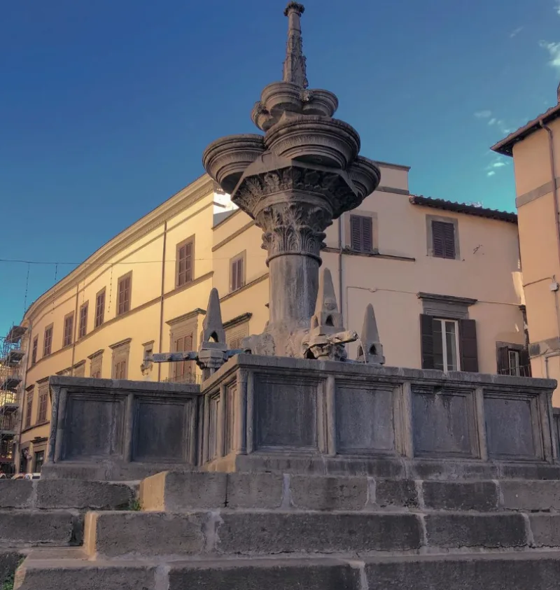 Fontana Grande Viterbo, Italy grey fontain on rocks under blue sky