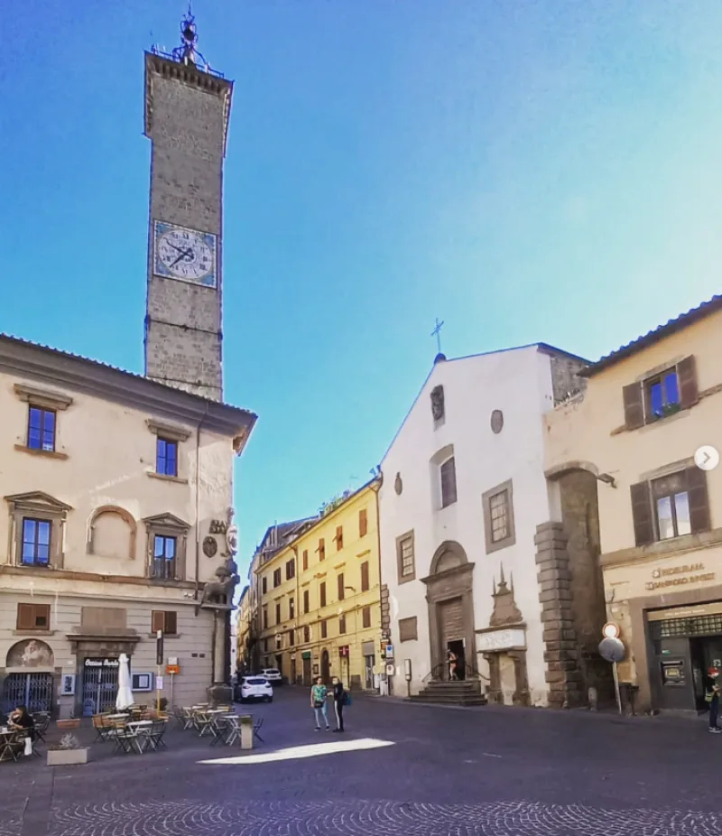 Piazza del Plebiscito Viterbo, Italy white and yellow houses under blue sky