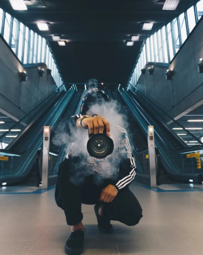 henyang, China man holding camera while smoking